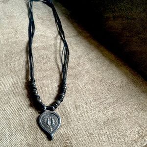 Beautiful vintage necklace. Leather strap. Don’t know what the beautiful piece.